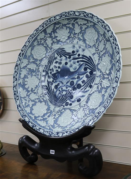 A large Chinese blue and white charger on stand